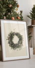 a picture of a christmas wreath on a table next to a christmas tree